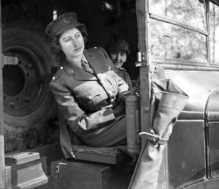 PRINCESS ELIZABETH AT THE WHEEL OF AN AMBULANCE WHILE A SECOND SUBALTERN IN THE A.T.S. - APRIL, 1945