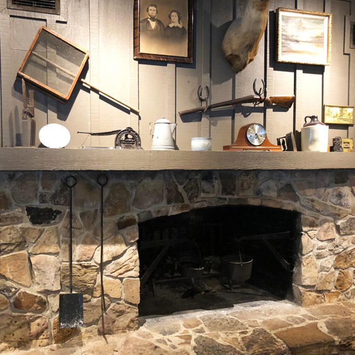 Nostalgic stone fireplace inside a Craker Barrel restaurant and Old Country Store.