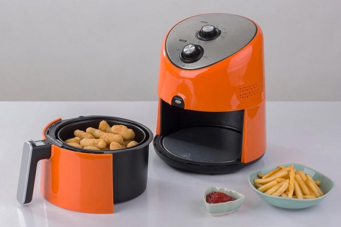 Air fryer machine with chicken and french fried