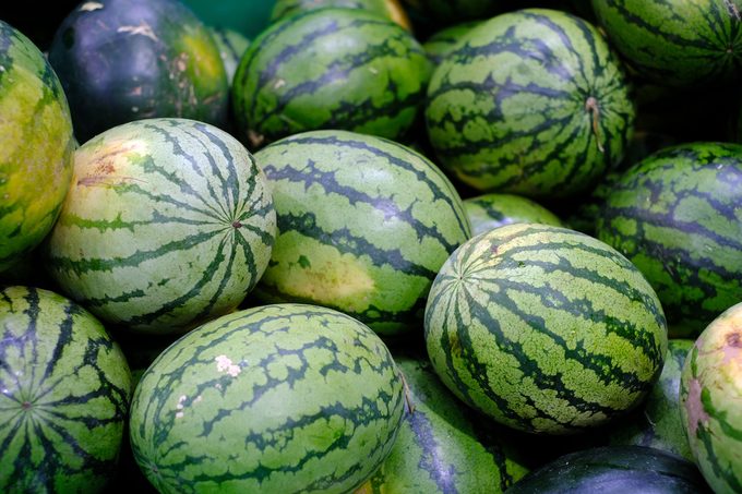 watermelons are stacked in a pile and ready to go to sale at the market