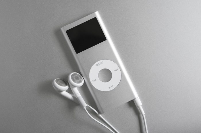 mp3 player and earbuds on silver surface