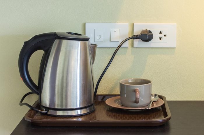 Cups and electric kettle was plugged in.