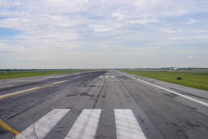Runway of an airport. An airplane just took off in the background