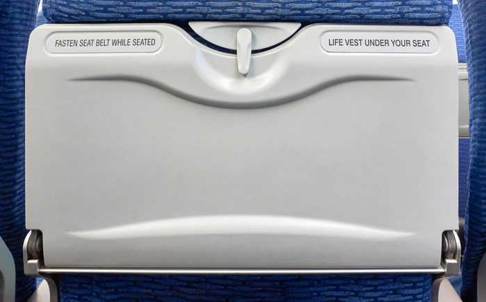 Airplane Tray Table on seat back for mockup banner or design advertising on blank area, already closed, copy space