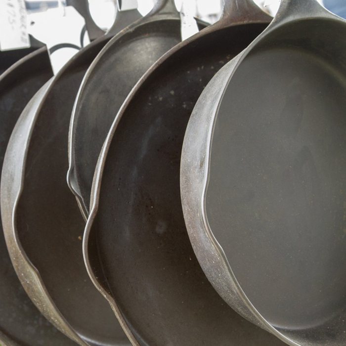 Hanging row of cast iron skillets at swap meet