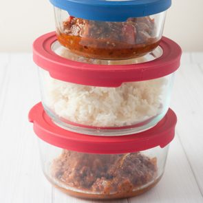 isolated close up of stack of glass containers with leftovers