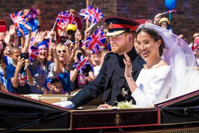 Mandatory Credit: Photo by Shutterstock (9686355b) Prince Harry and Meghan Markle during the Carriage Procession of their wedding in Windsor, Berkshire, UK. The wedding of Prince Harry and Meghan Markle, Windsor, UK - 19 May 2018