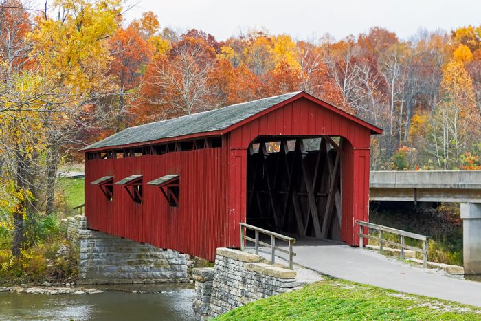 Indiana's Cataract Covered Bridge is photographed with brilliant fall foliage.
