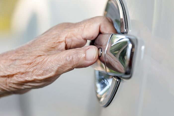 elderly woman hand opening car door