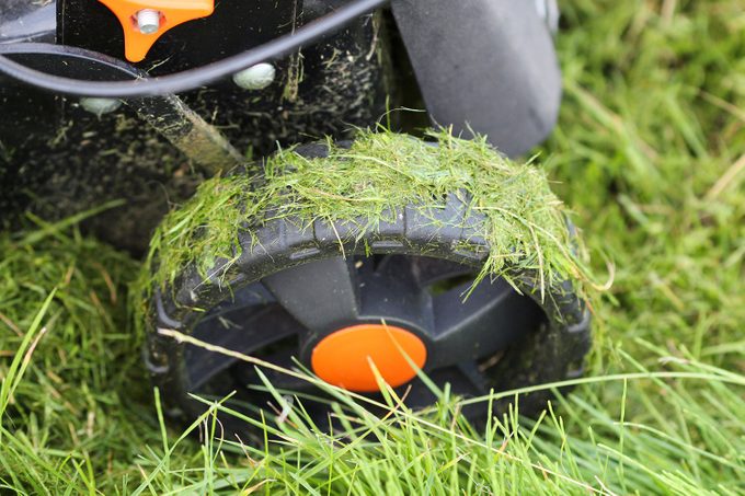 wet grass stuck to lawn mower tires