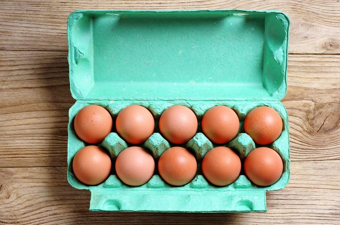 dozen brown eggs in carton