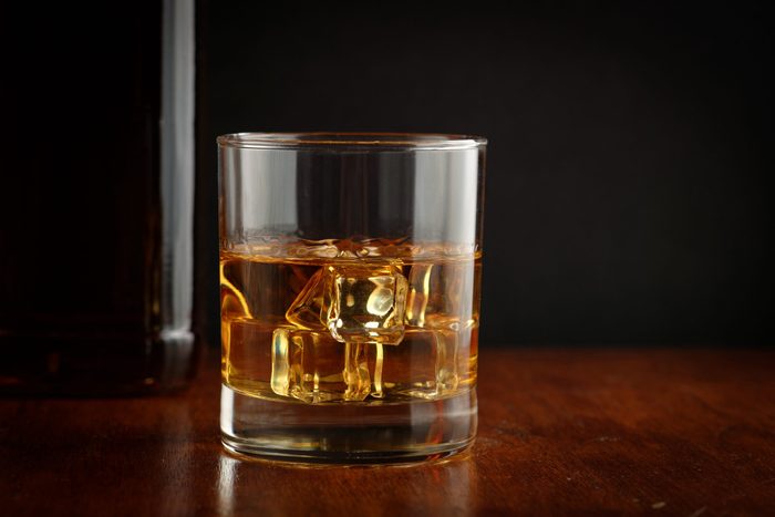 Bourbon whiskey on whiskey glass with rustic and dark theme