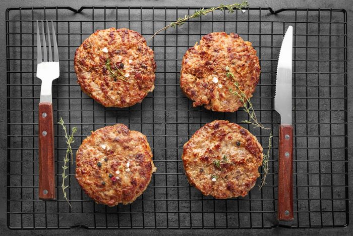 Delicious burger patties on cooling rack