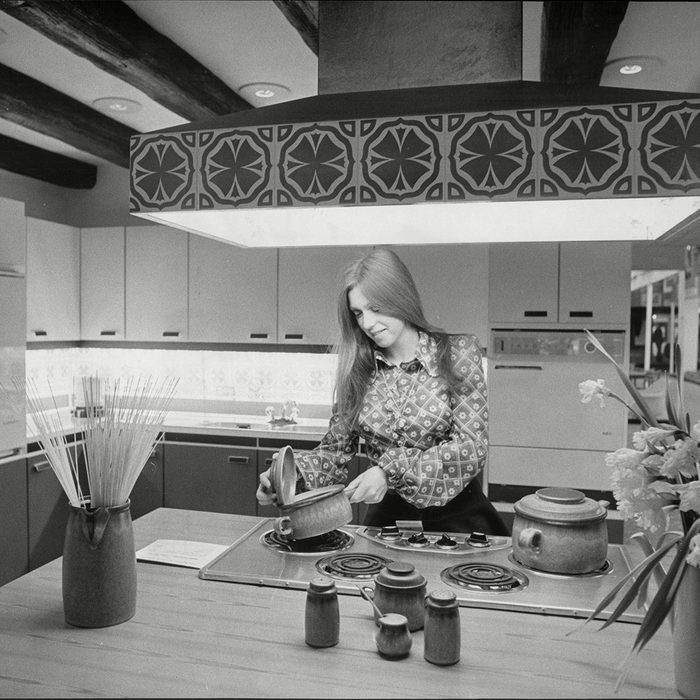 Model Cooking In Kitchen Of The Show House At The Ideal Home Exhibition 1972. 