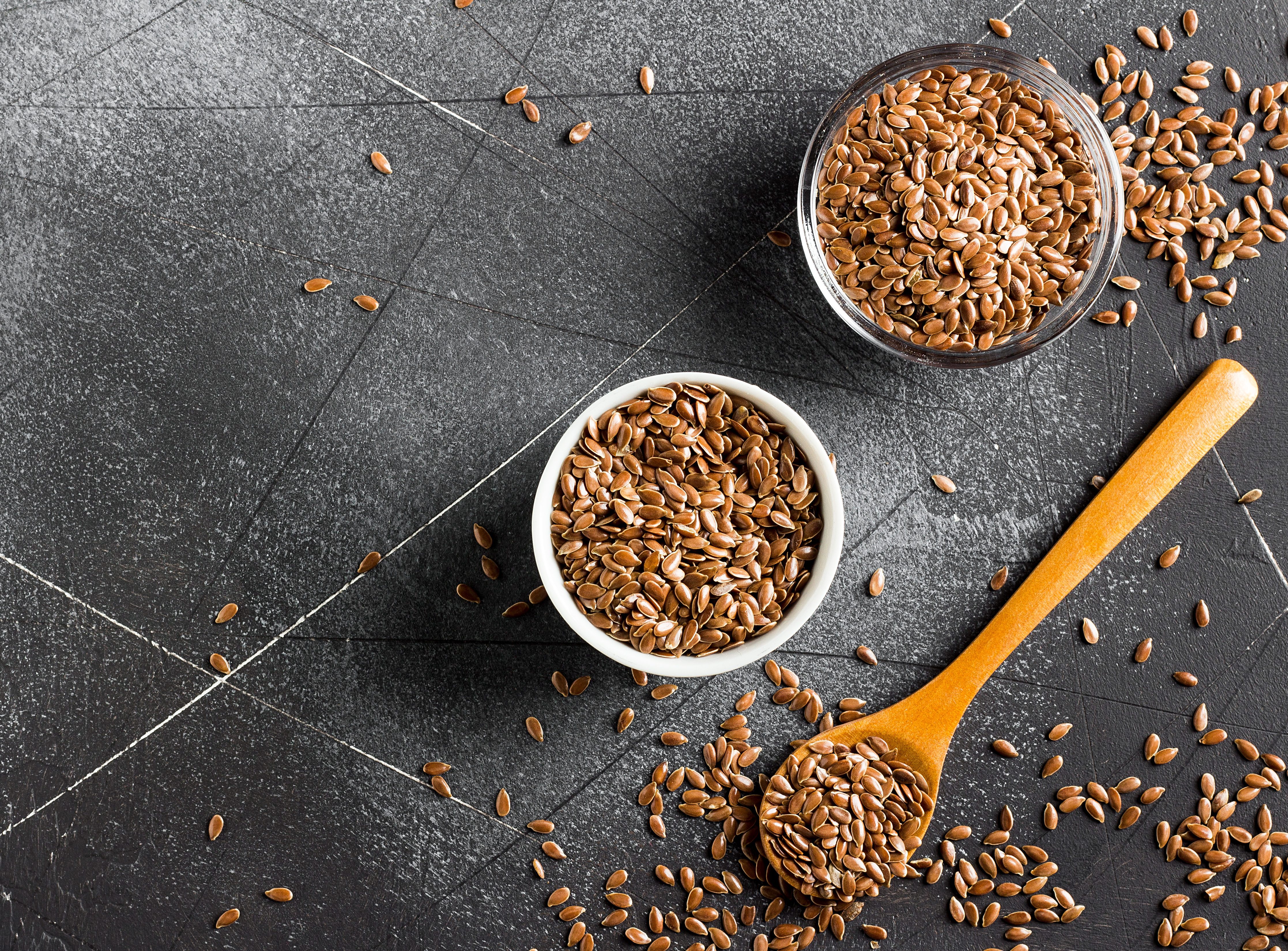 Flax seeds linseed superfood healthy organic food concept on dark background with copy space top view