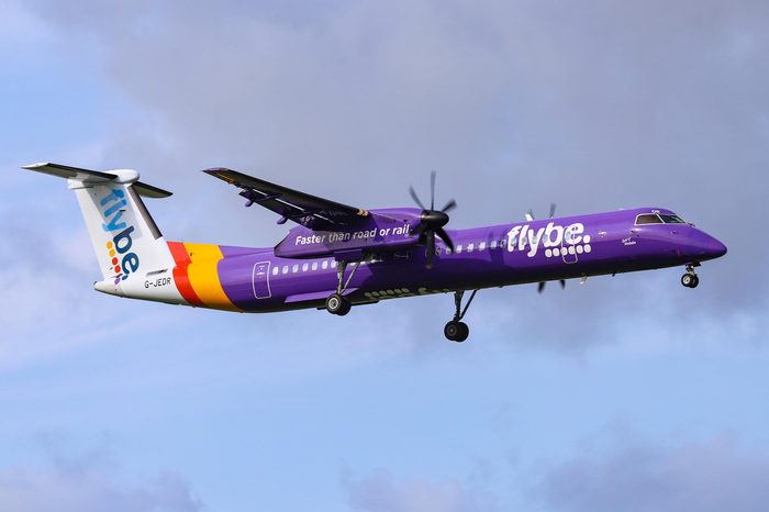 Flybe landing in Amsterdam. Aircraft type is De Havilland Canada DHC-8-400 with registration G-JEDR and name Spirit of Dublin. Amsterdam, Netherlands - August 30, 2018