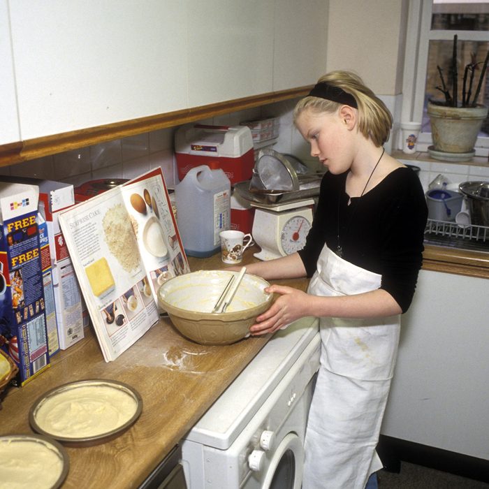 Girl baking cake in kitchen