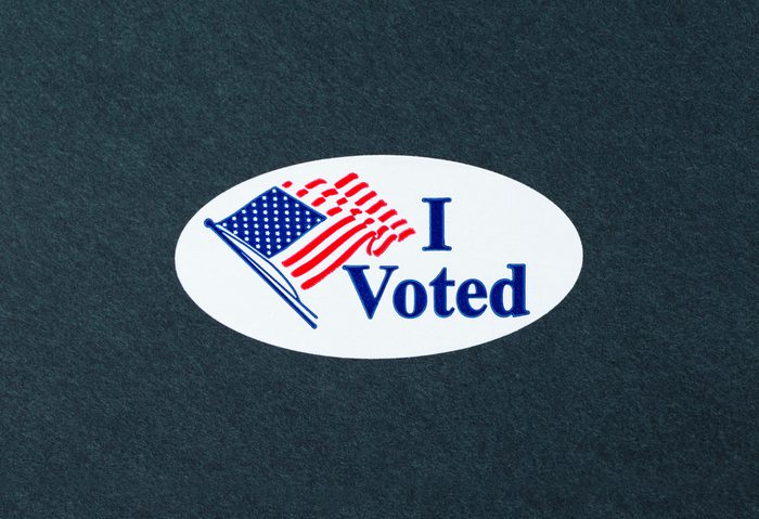 'I Voted' sticker on the black background.