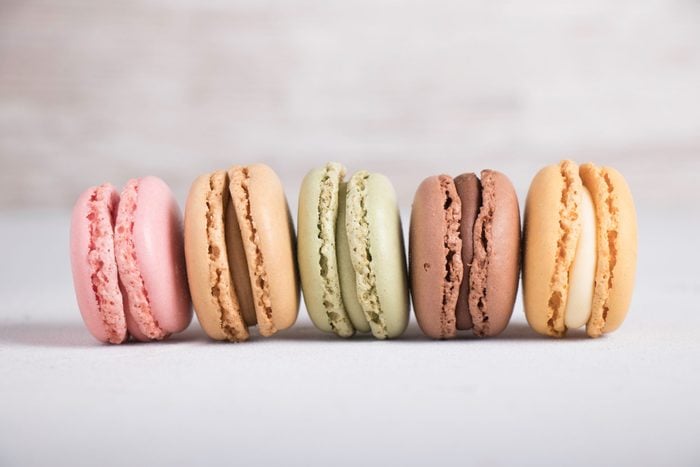 Colorful pastel macarons on gray background