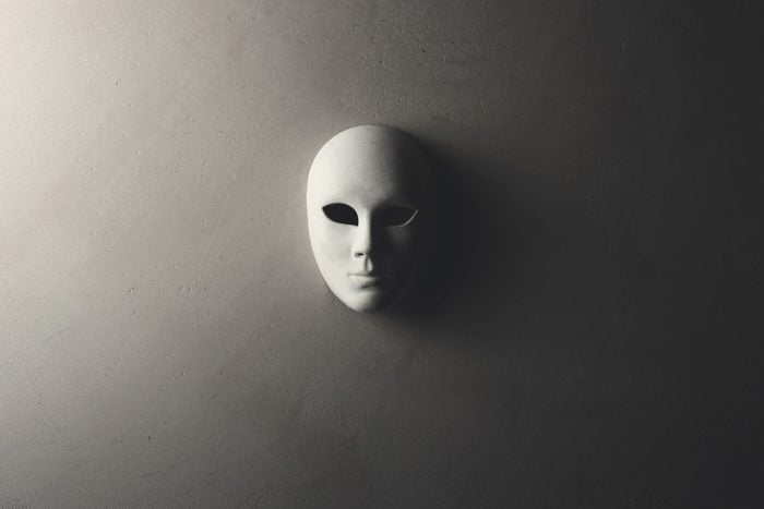 White mask on the dark wall