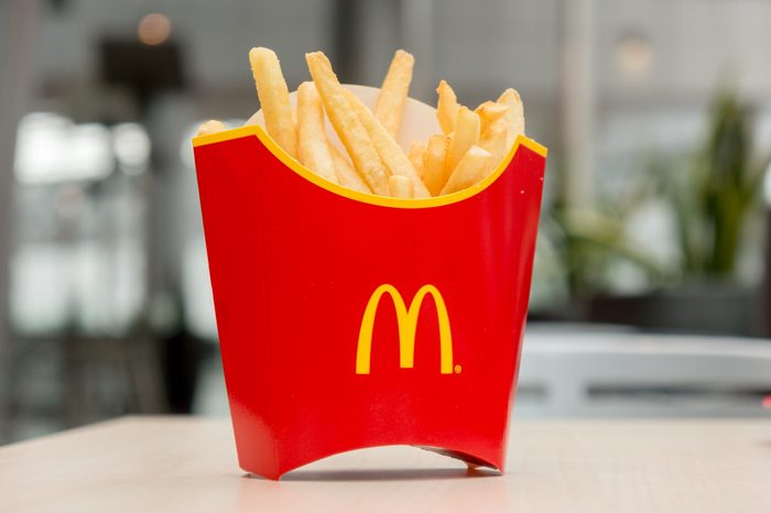 Moscow, Russia, March 15 2018: McDonald's potato french fries in the red box on wooden background