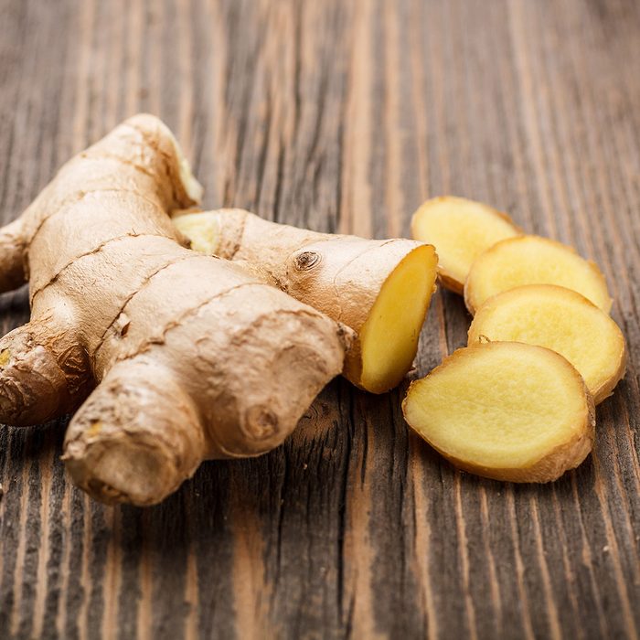 Ginger root sliced on wooden table; Shutterstock ID 127542449
