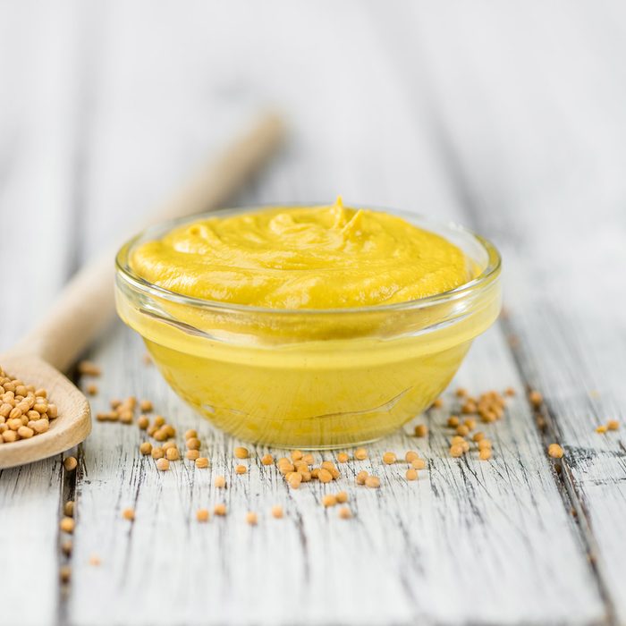 Fresh made Mustard on a vintage background (close-up shot); Shutterstock ID 562035217