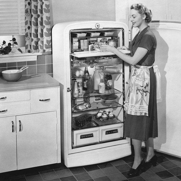Woman with open refrigerator; Shutterstock ID 99385886