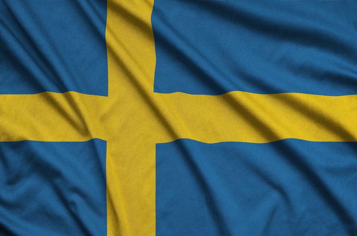 Sweden flag is depicted on a sports cloth fabric with many folds. Sport team banner