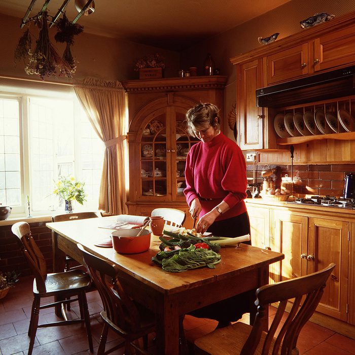 WOMAN IN THE KITCHEN PREPARING FOOD