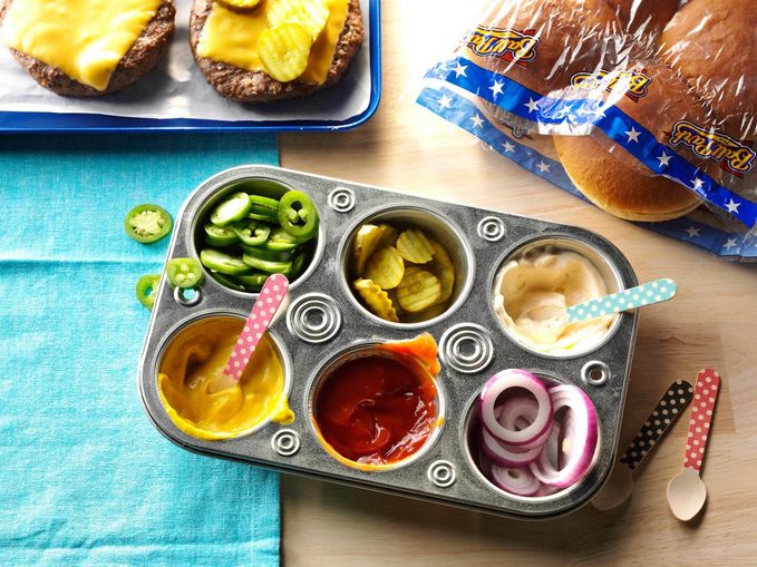 Muffin tin filled with condiments for party