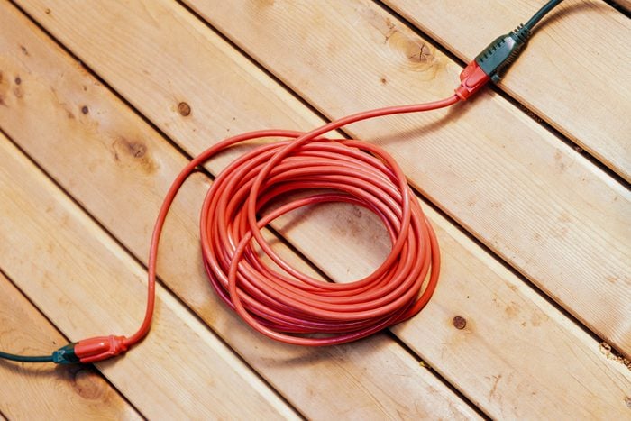 Electrical Extension Cord On Wooden Deck