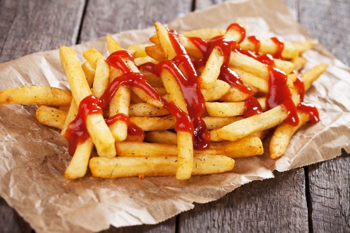 French fries with ketchup served on parchment paper