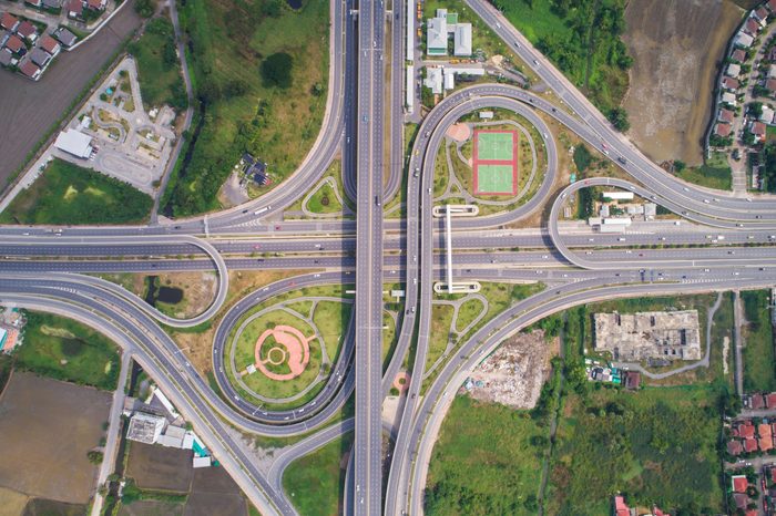 Intersection traffic circle road with car and green tree look down view