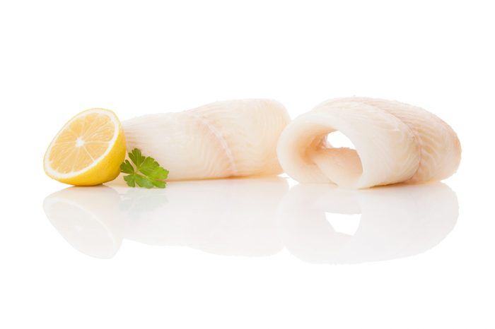 Raw fresh halibut steak isolated on white background. Culinary healthy seafood eating. 