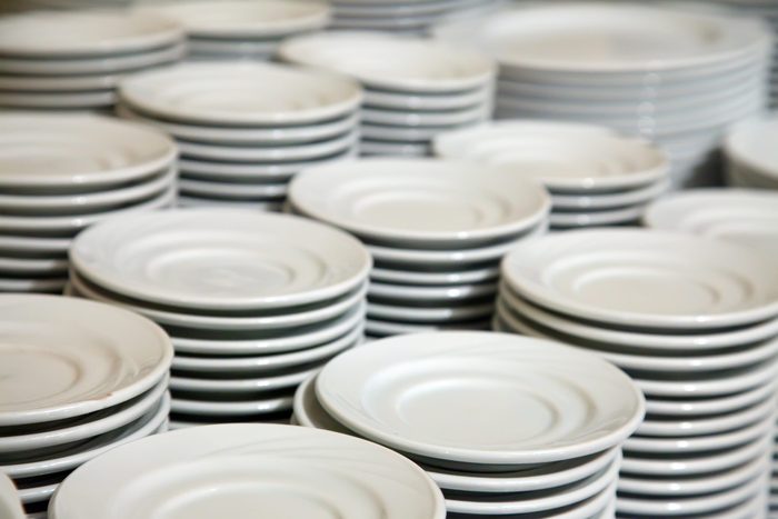 Many white different plates stacked together