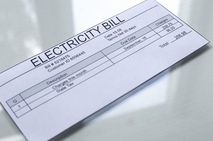 Electricity bill lying on table, payment for services, month expenses, tariff