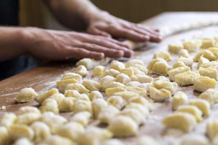 Hands preparing fresh italian pasta gnocchi.