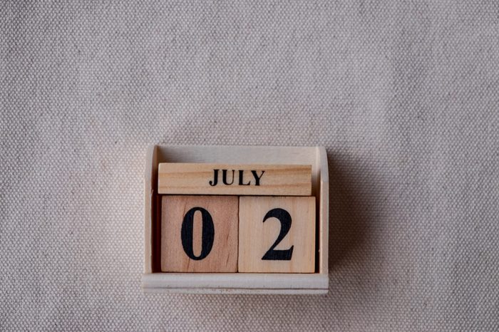 July 2nd. Image of July 2 wooden color calendar on white canvas background. empty space for text 