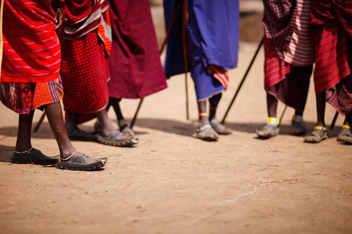 Group of masai people participating in traditional dance with high jumps