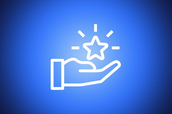 icon of a hand holding a glowing star on blue background