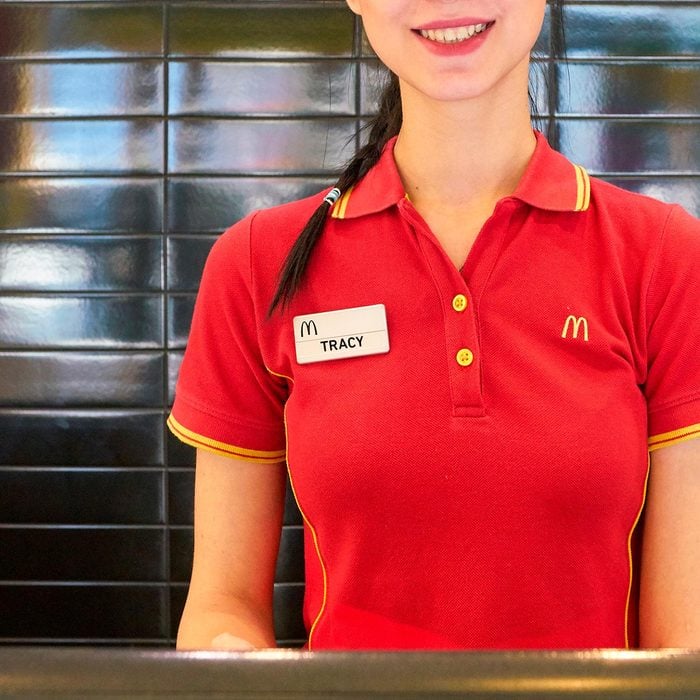 close up on a name tag of a woman working the register in a fast food restaurant