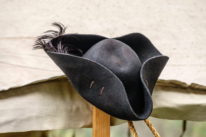 Feathered black felt hat, for man or woman, on tentpole in a military camp at a reenactment of the American Revolutionary War (1775-1783)
