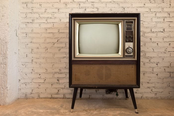Retro old television in vintage white wall background