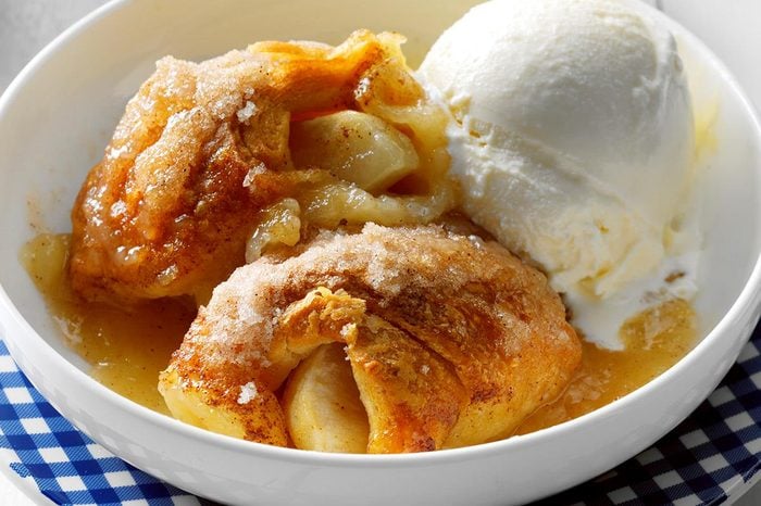 A bowl of Apple Dumpling Bake with melting vanilla ice cream