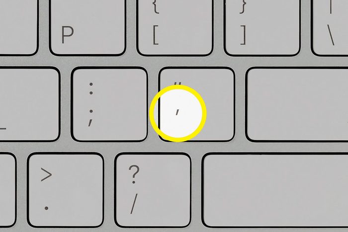 close up of computer keyboard with apostrophe key highlighted