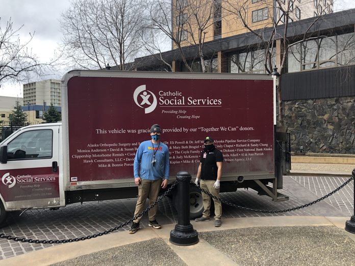 Catholic Social Services volunteers stand by their truck in Anchorage, Alaska