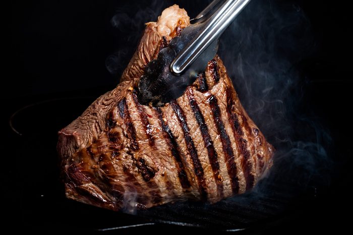Large piece of fresh beef meat prepared on a grill pan. Toned.