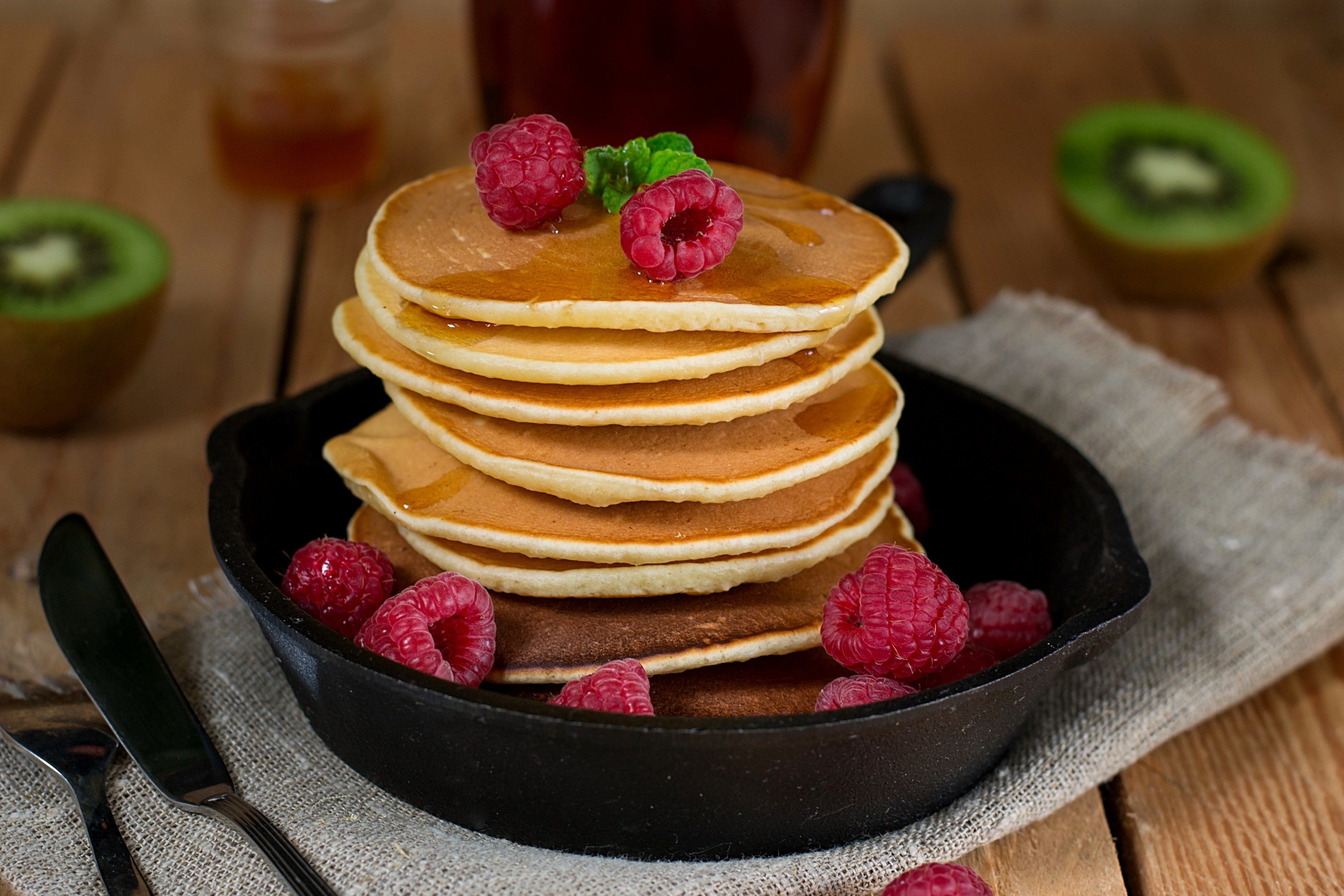 Pancakes hotcakes with fresh berries and fruit served with maple syrup