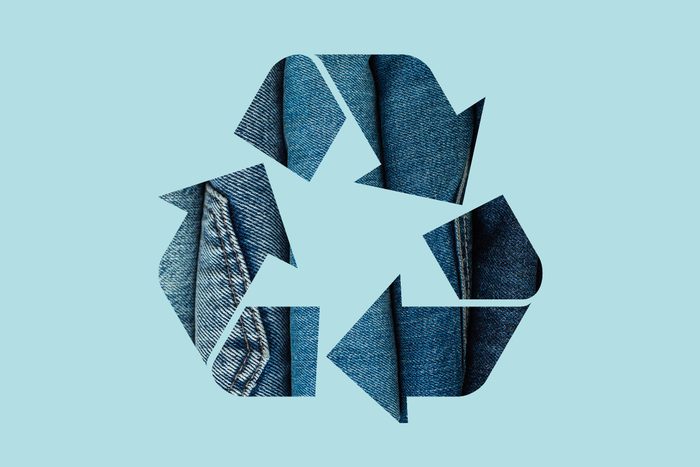 denim jeans in a recycle symbol on a blue background
